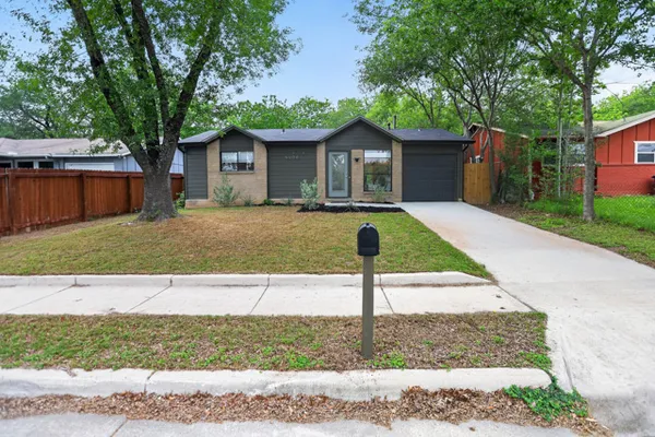 a front view of house with yard and trees