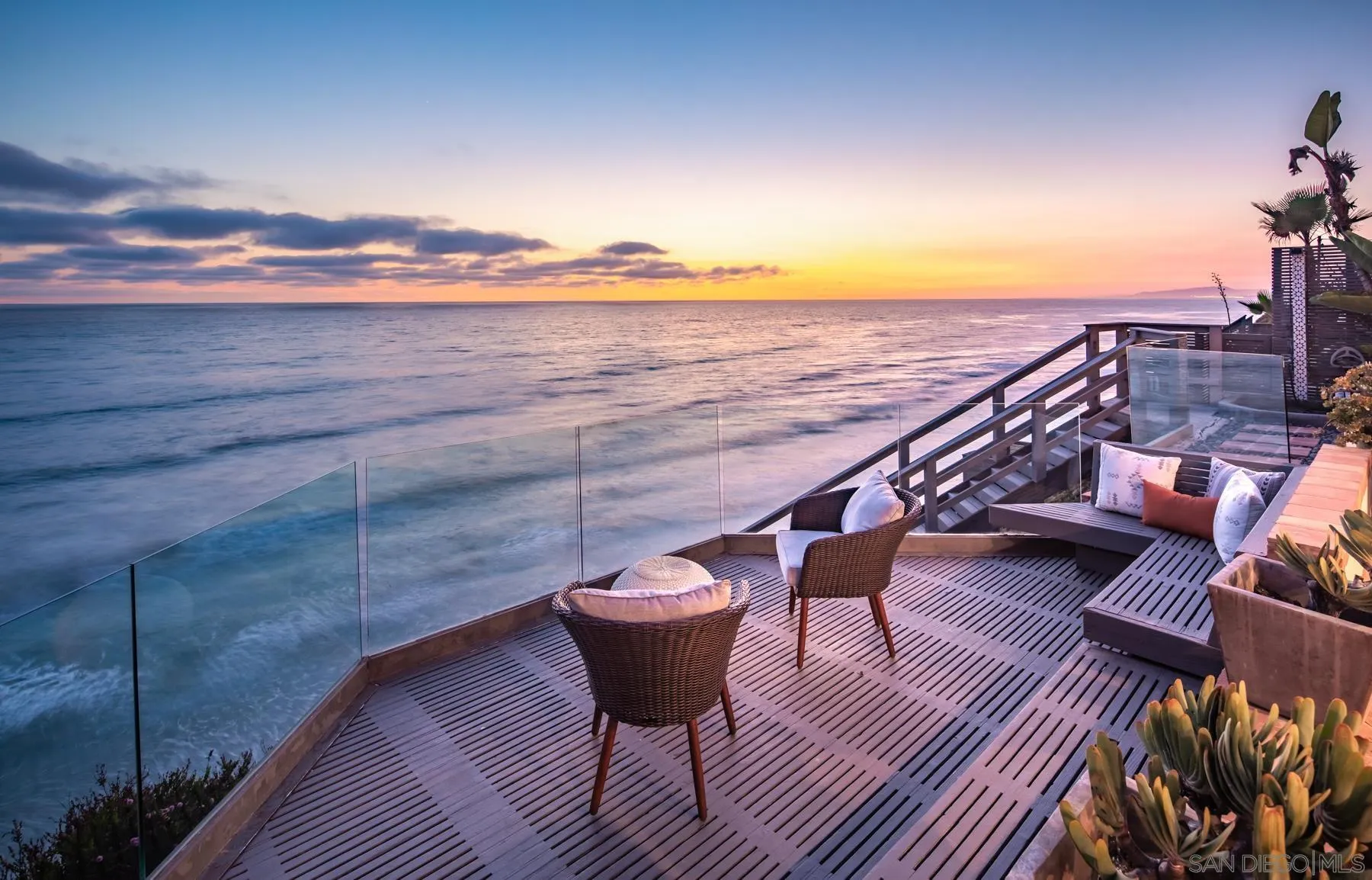 a view of a balcony with wooden floor and outdoor seating