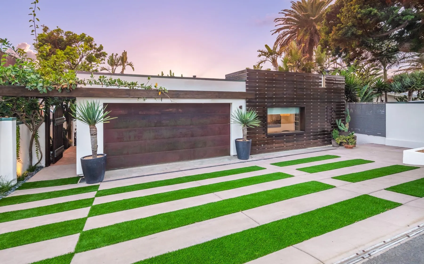 1370 Neptune Avenue Encinitas, CA 92024 - Photo 8 of 52 a front view of a house with a garden and plants