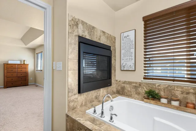 a bathroom with bathtub and window