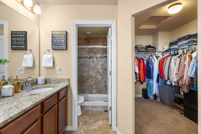 a view of walk in closet with clothes
