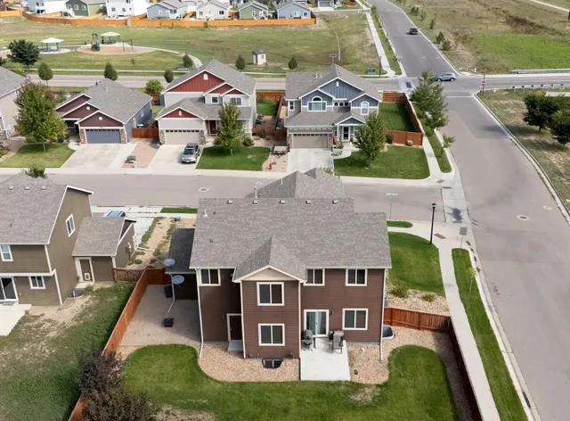 an aerial view of a house with swimming pool and a yard