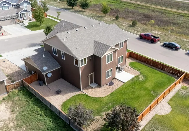 a aerial view of a house with a yard