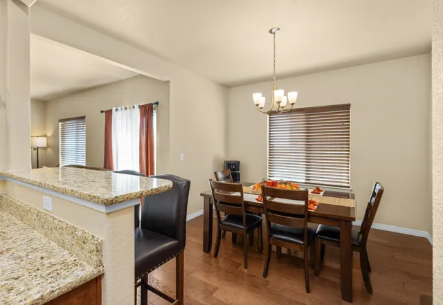 a view of a dining room with furniture and window