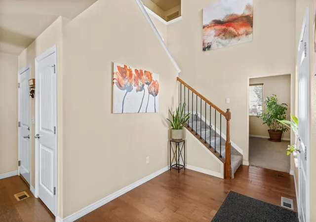 a view of entryway with stairs and wooden floor