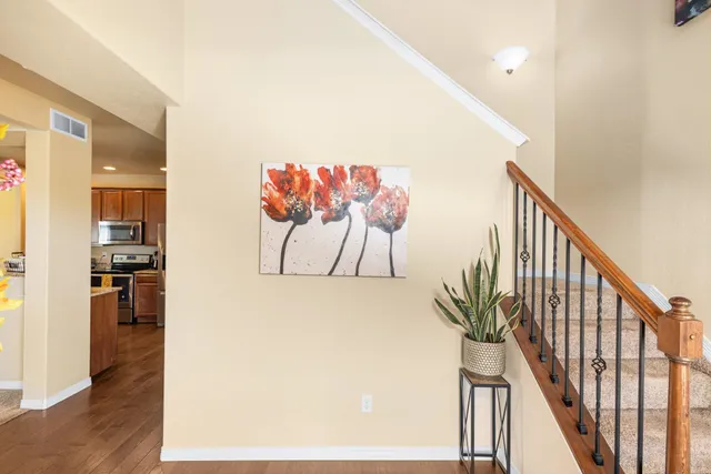a view of a hallway with wooden floor and staircase