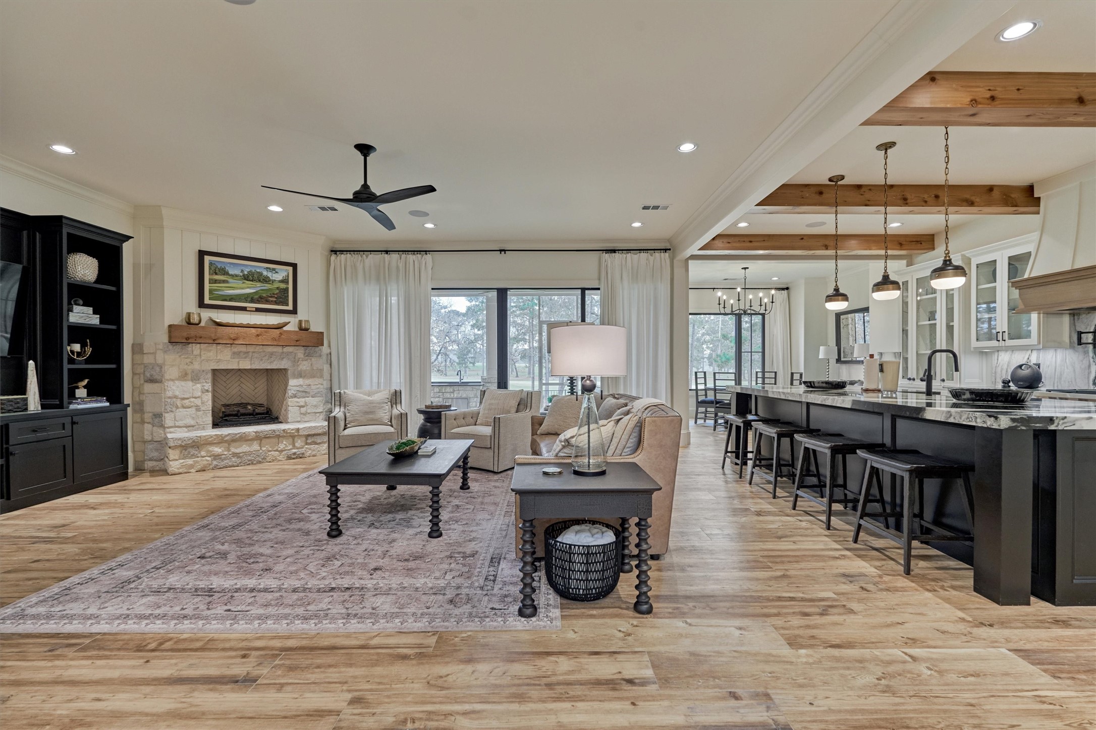 4469 Lily Bean Road Montgomery, TX 77316 - Photo 12 of 50 a living room with furniture a fireplace and a dining table with wooden floor