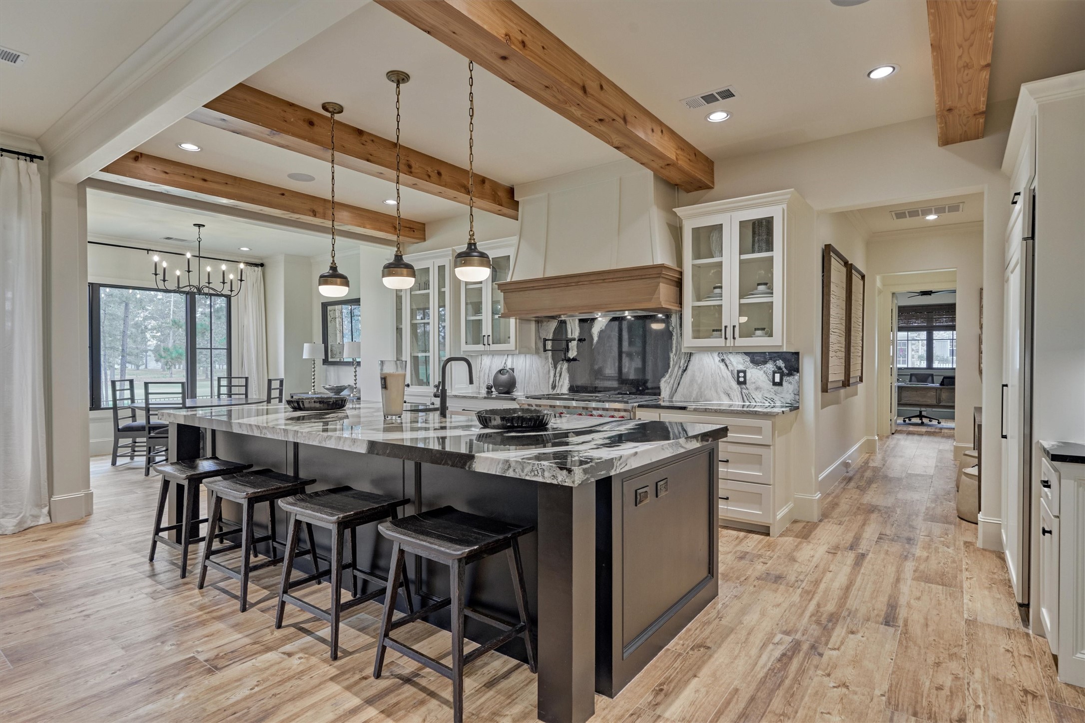 4469 Lily Bean Road Montgomery, TX 77316 - Photo 13 of 50 a kitchen with granite countertop a table chairs stove and cabinets