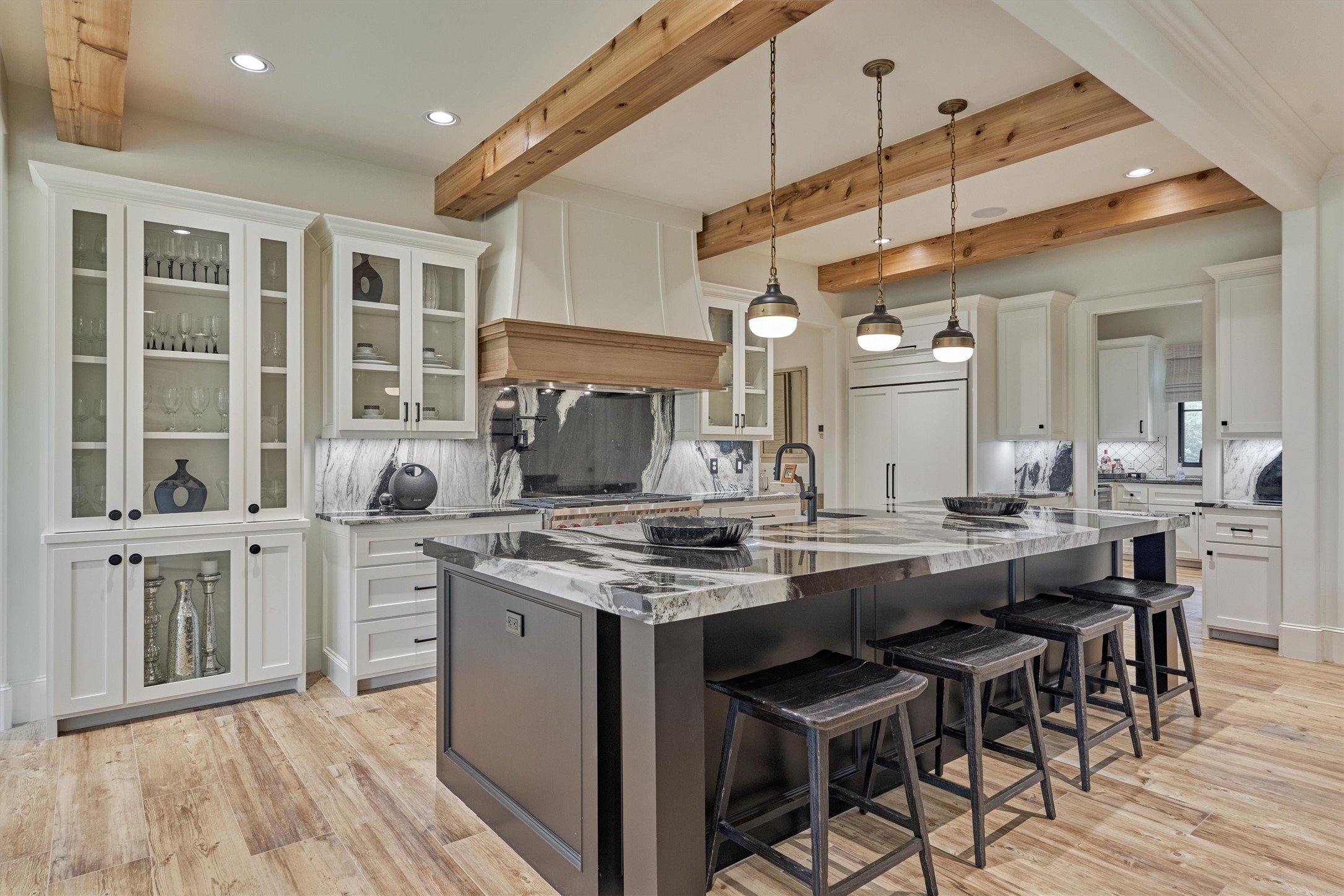 4469 Lily Bean Road Montgomery, TX 77316 - Photo 15 of 50 a kitchen with a stove a sink a dining table and chairs