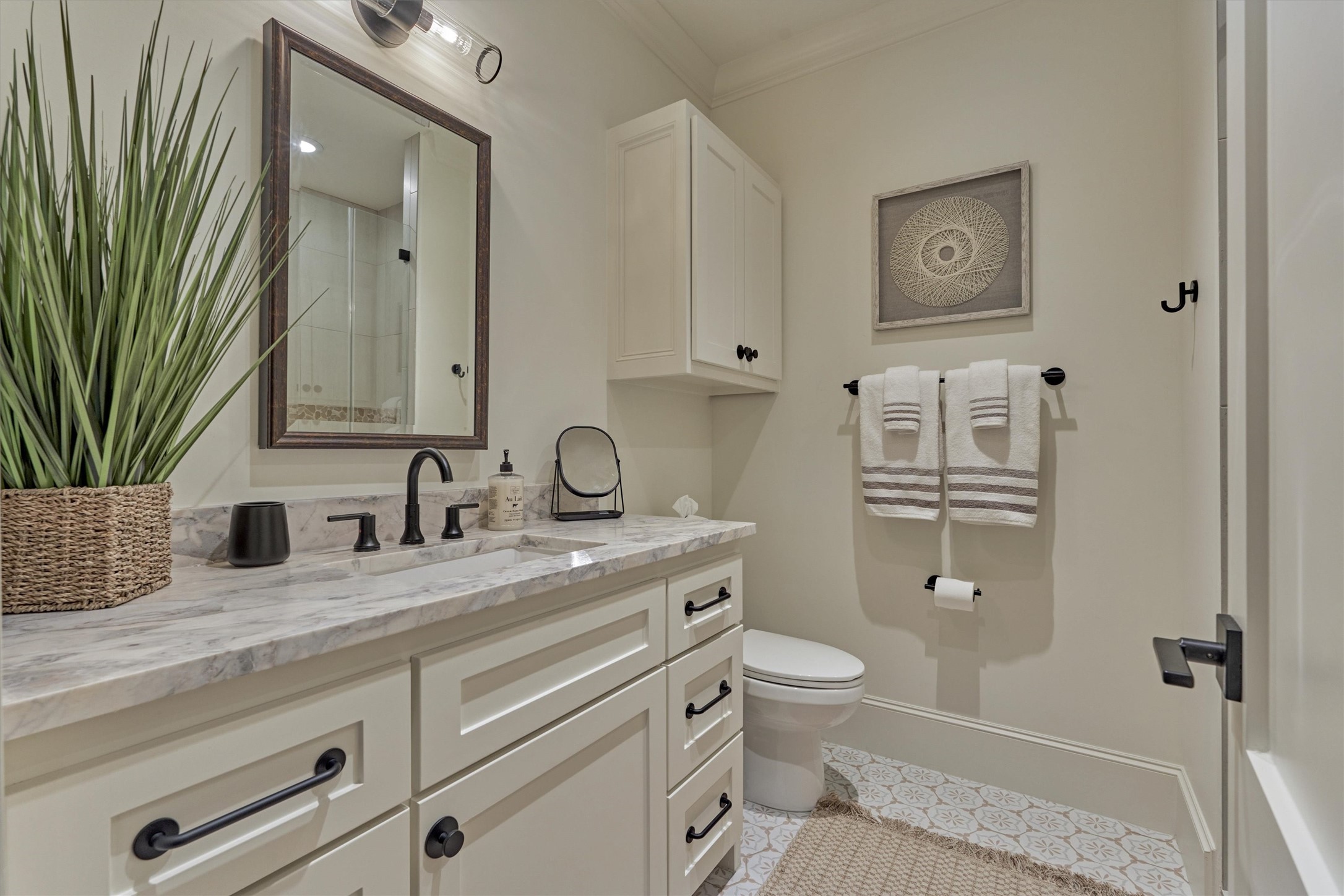 4469 Lily Bean Road Montgomery, TX 77316 - Photo 34 of 50 a bathroom with a granite countertop toilet sink and mirror