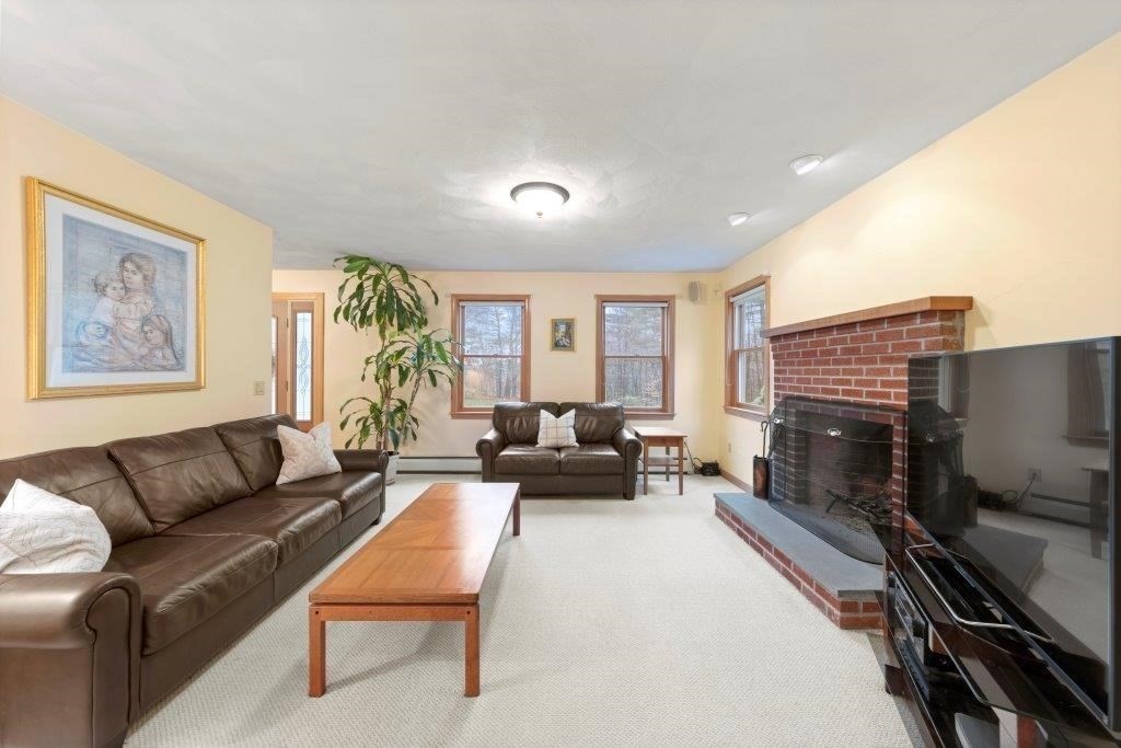 16 Stagecoach Road Princeton, MA 01541 - Photo 18 of 40 a living room with furniture a large window and a fireplace