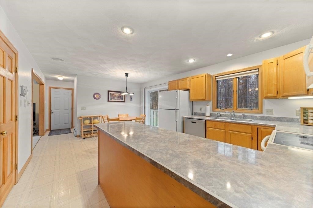 16 Stagecoach Road Princeton, MA 01541 - Photo 7 of 40 a large kitchen with stainless steel appliances granite countertop a large counter top and a stove