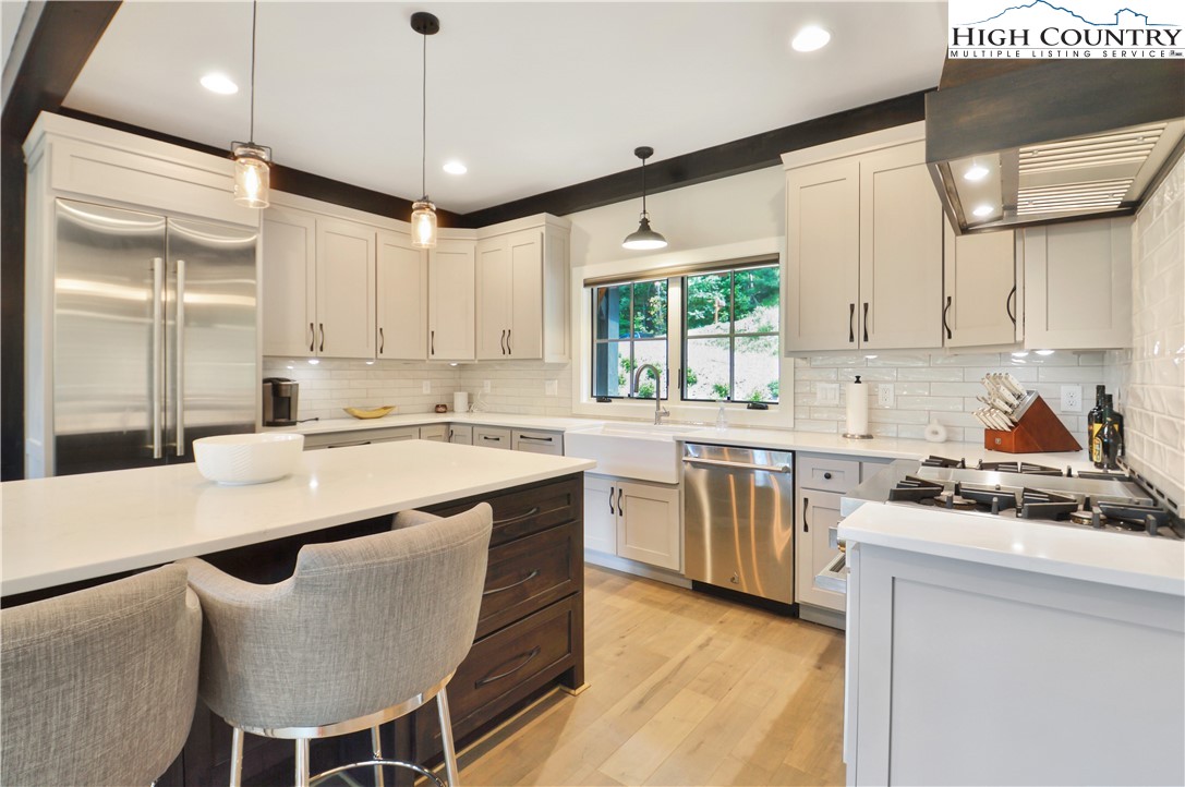 1736 Twin Rivers Drive Boone, NC 28607 - Photo 12 of 46 a kitchen with stainless steel appliances granite countertop a stove a sink and a refrigerator