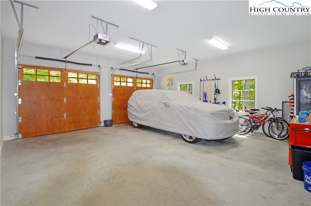 1736 Twin Rivers Drive Boone, NC 28607 - Photo 38 of 46 a spacious bedroom with a bed and a chandelier
