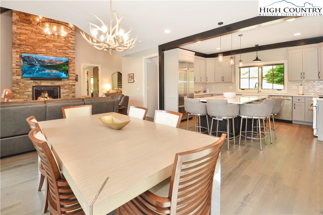 1736 Twin Rivers Drive Boone, NC 28607 - Photo 10 of 46 a dining room with wooden floor and large windows