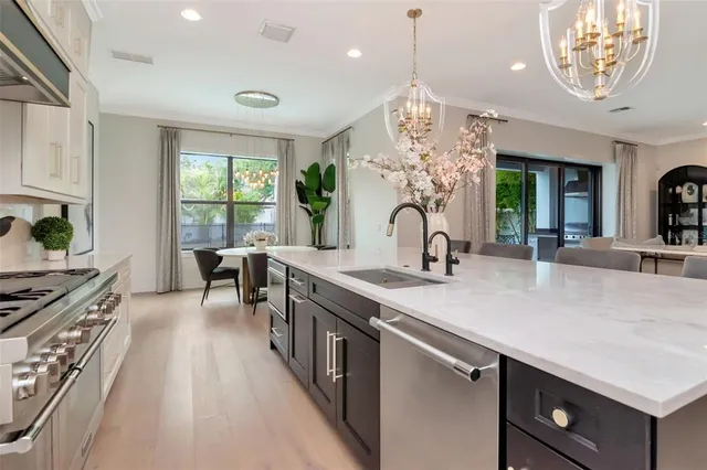 a kitchen with counter top space a sink appliances and cabinets