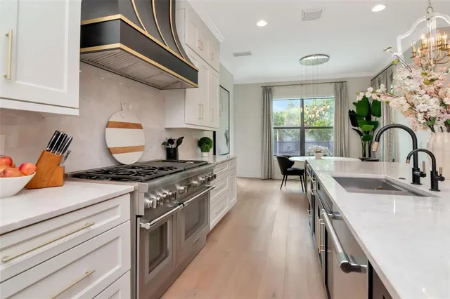 a kitchen with stainless steel appliances granite countertop a stove and a sink