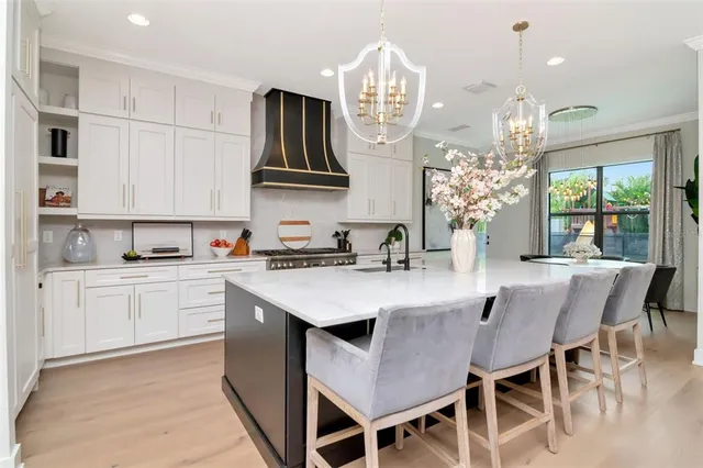 a kitchen with cabinets appliances and a center island