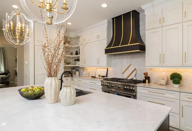 a kitchen with stainless steel appliances a sink a stove and cabinets