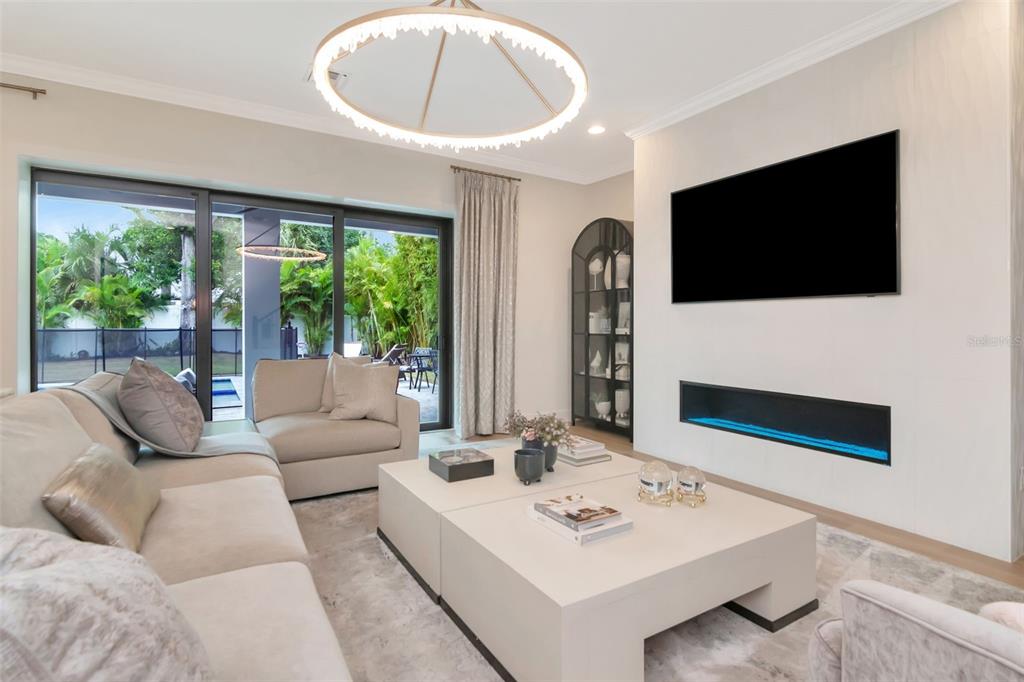 4111 West Swann Avenue Tampa, FL 33609 - Photo 22 of 49 a living room with couches a coffee table and a flat screen tv