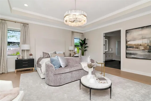 a living room with furniture and a chandelier