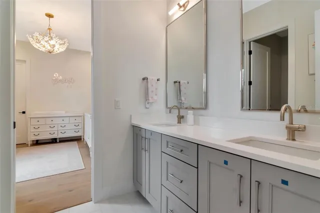 a bathroom with a sink double vanity and a mirror