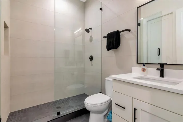 a bathroom with a sink toilet and shower