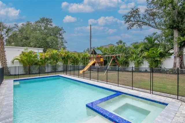 a view of a backyard with swimming pool