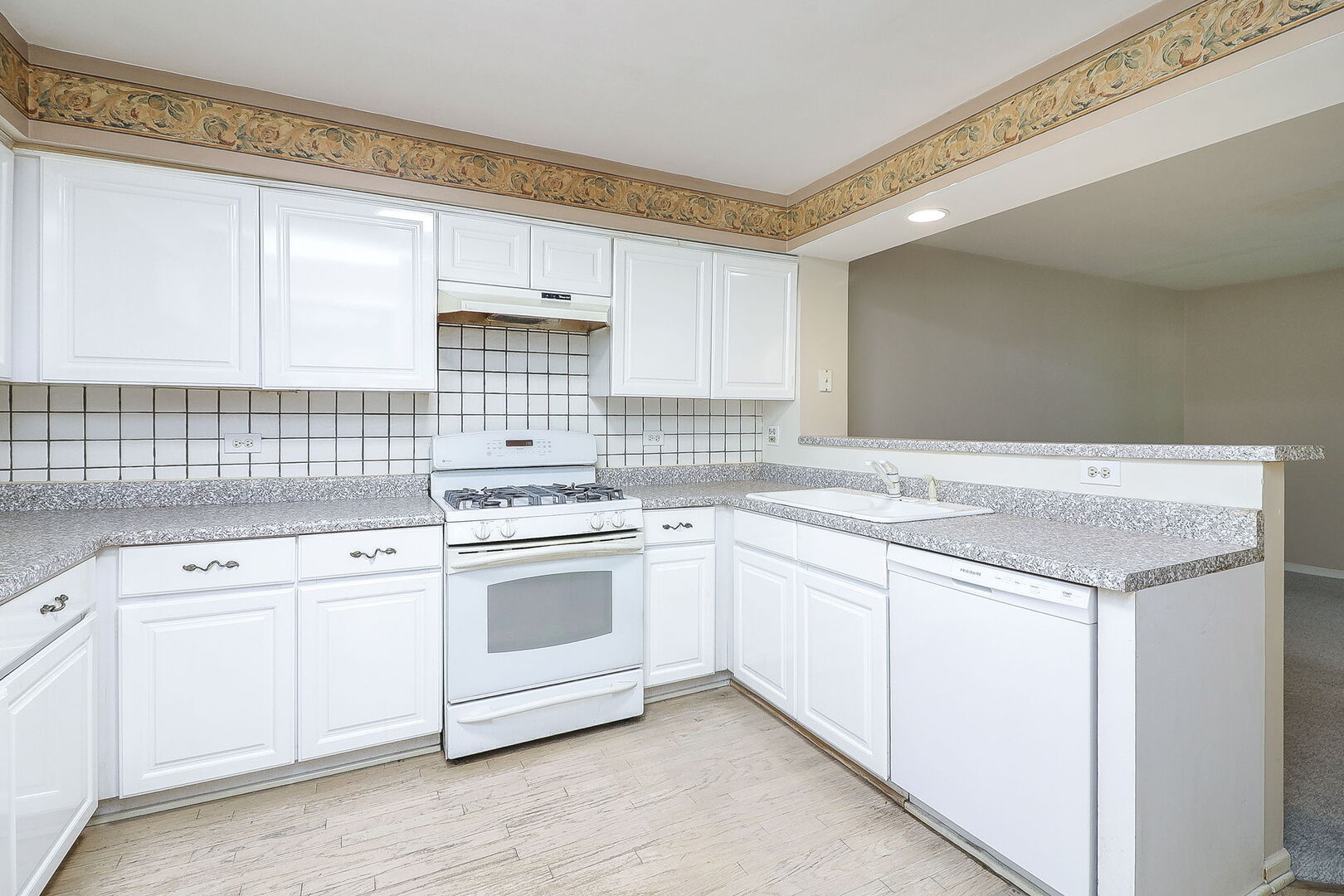 164 Springdale Lane Bloomingdale, IL 60108 - Photo 7 of 30 a kitchen with granite countertop white cabinets and white appliances