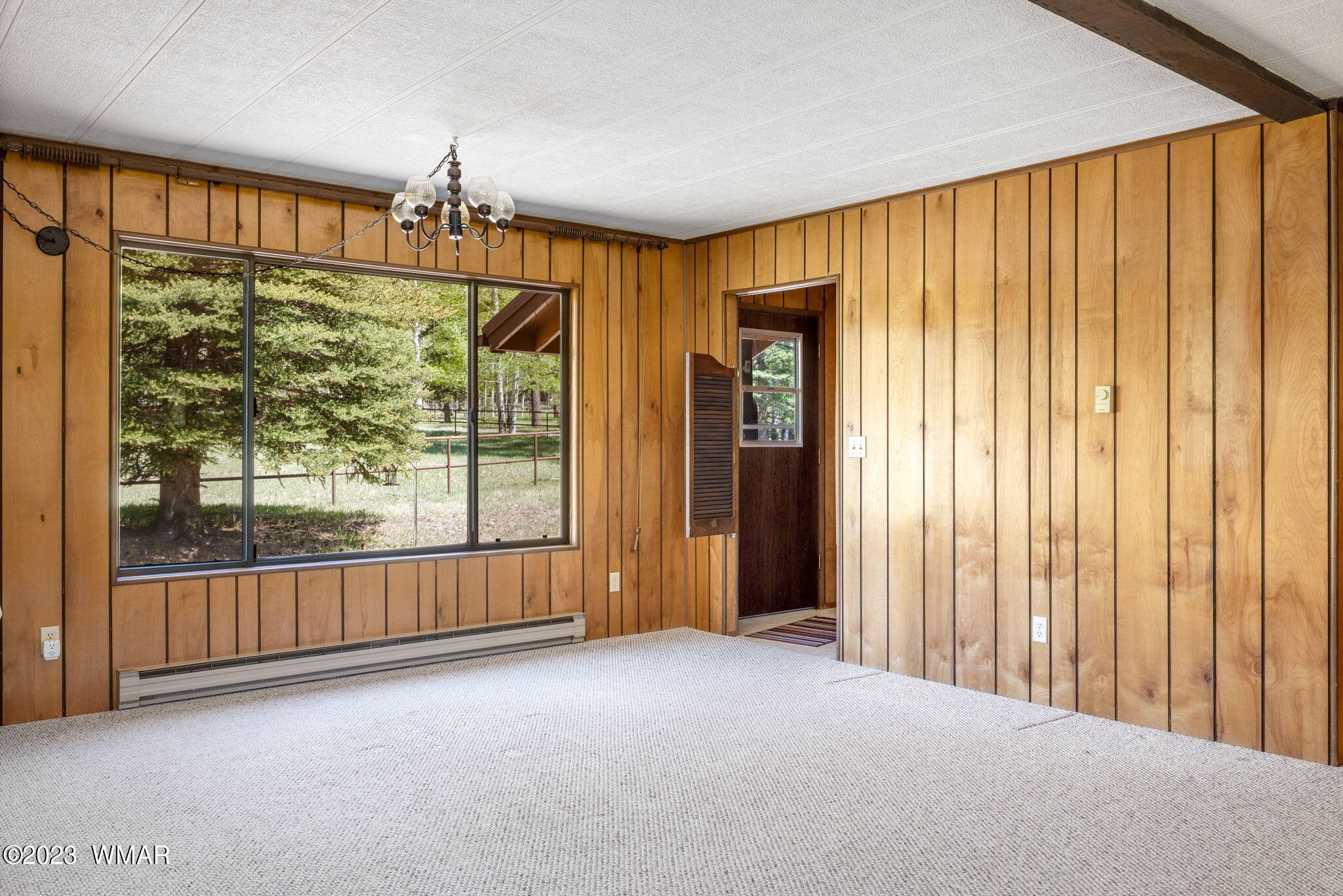 7 County Road 2043 Alpine, AZ 85920 - Photo 11 of 32 an empty room with floor to ceiling windows and an outdoor view