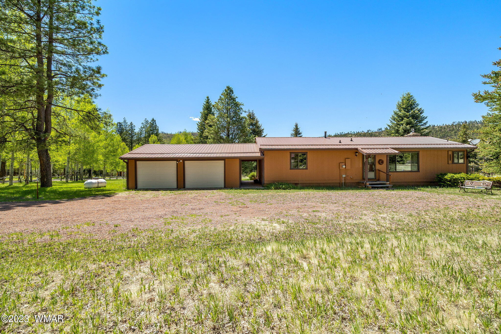 7 County Road 2043 Alpine, AZ 85920 - Photo 22 of 32 a front view of a house with a yard and a garage