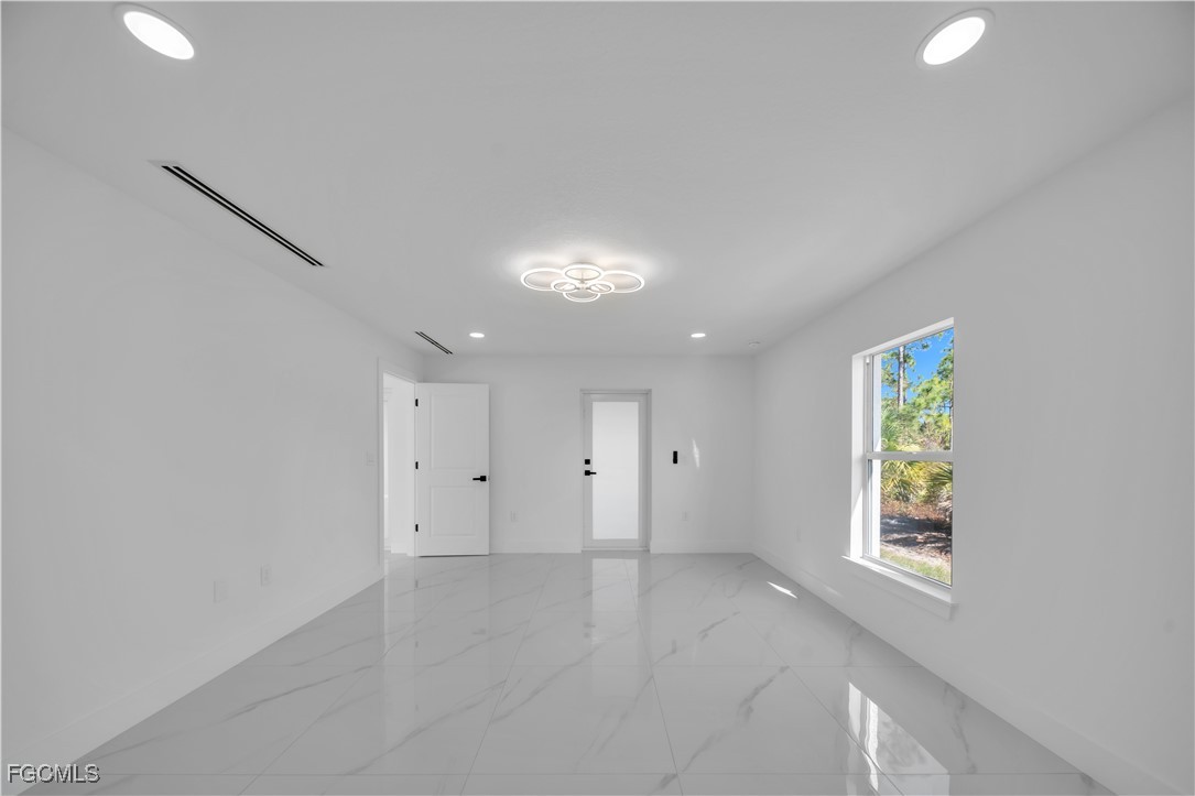 855 Foxtail Street East Lehigh Acres, FL 33974 - Photo 13 of 23 a view of an empty room with a window