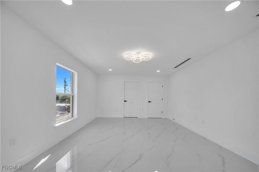 855 Foxtail Street East Lehigh Acres, FL 33974 - Photo 14 of 23 an empty room with windows