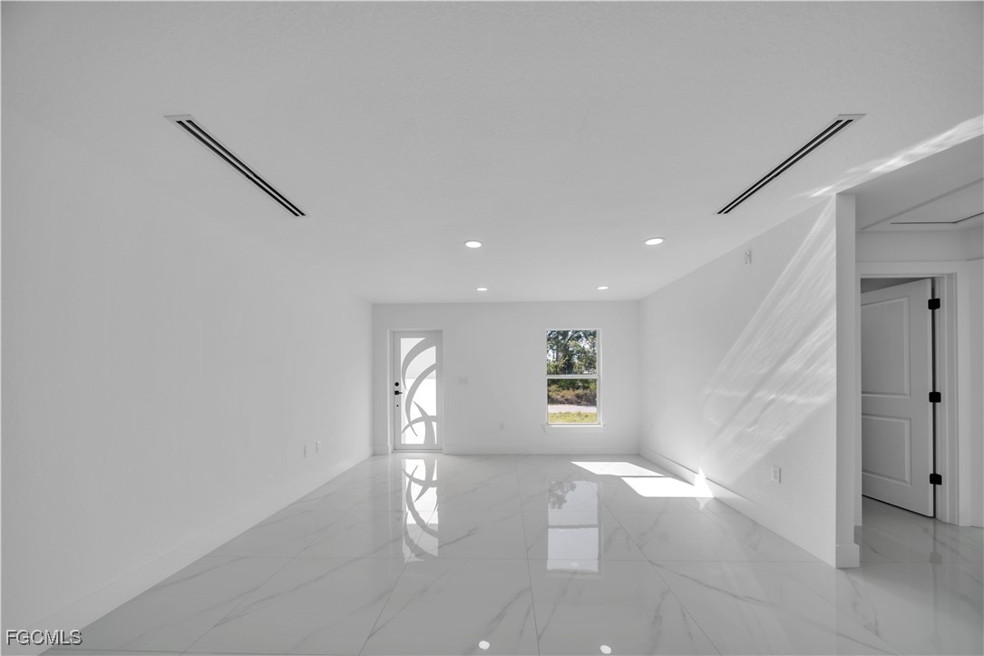 855 Foxtail Street East Lehigh Acres, FL 33974 - Photo 2 of 23 a view of empty room with windows