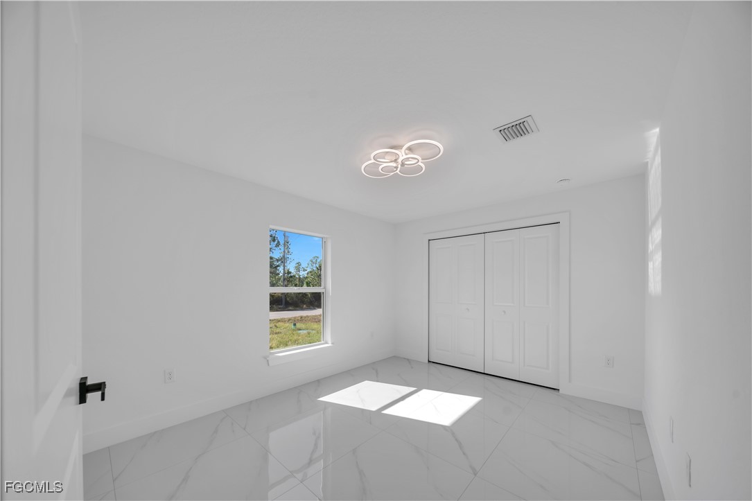 855 Foxtail Street East Lehigh Acres, FL 33974 - Photo 8 of 23 a view of an empty room with a window