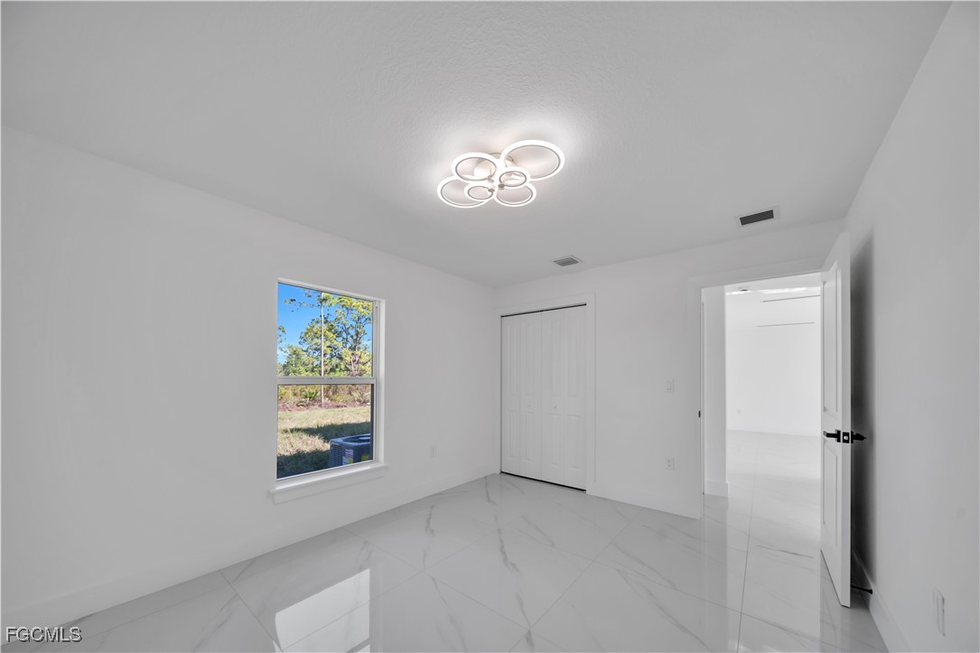 855 Foxtail Street East Lehigh Acres, FL 33974 - Photo 9 of 23 an empty room with a window