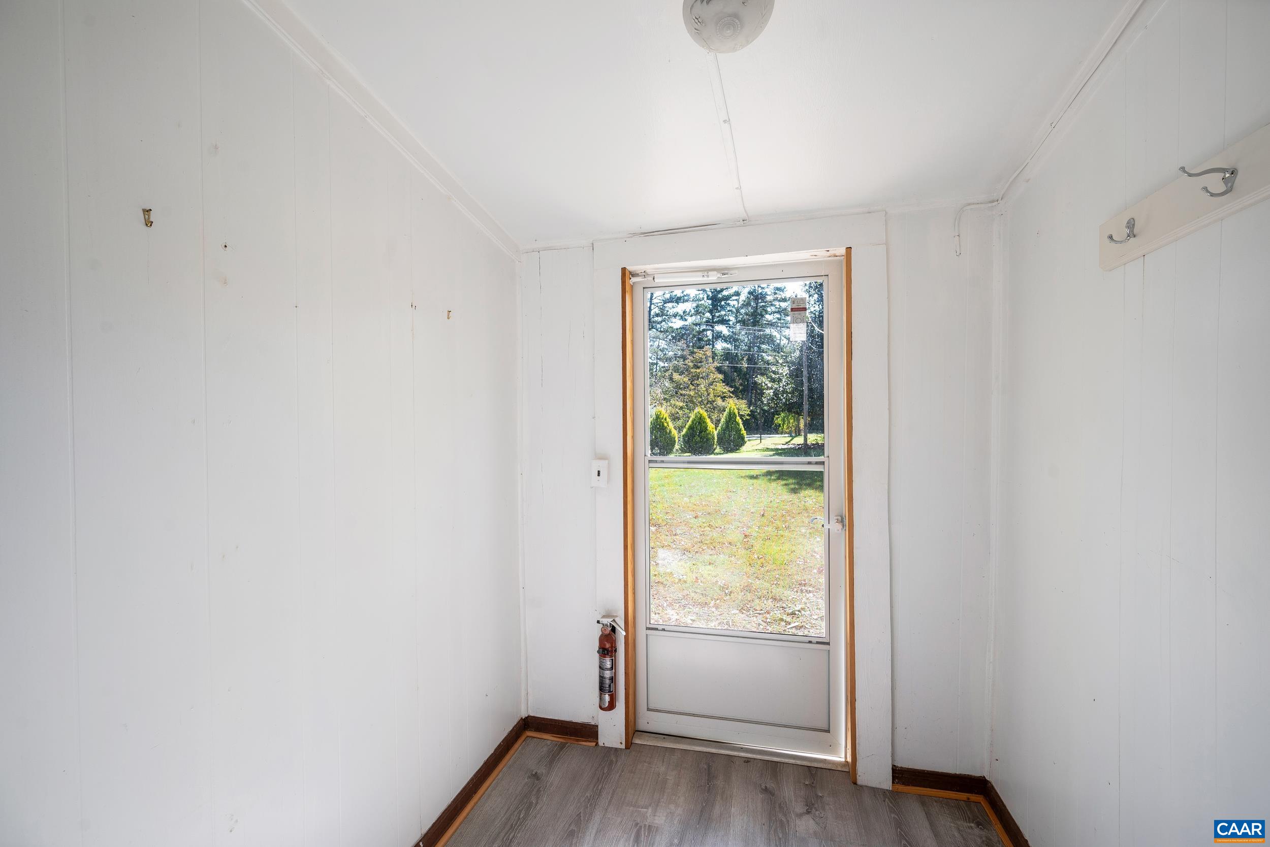 9915 Howardsville Road Howardsville, VA 24562 - Photo 39 of 68 a view of an empty room with wooden floor and a window