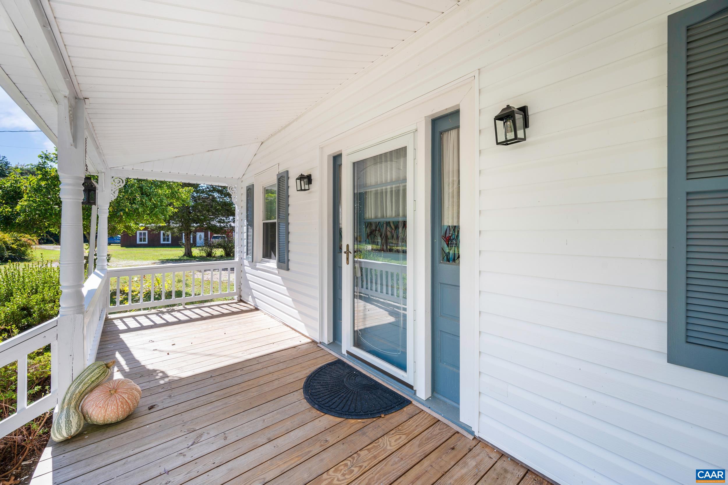 9915 Howardsville Road Howardsville, VA 24562 - Photo 6 of 68 a view of a porch with wooden floor and iron stairs