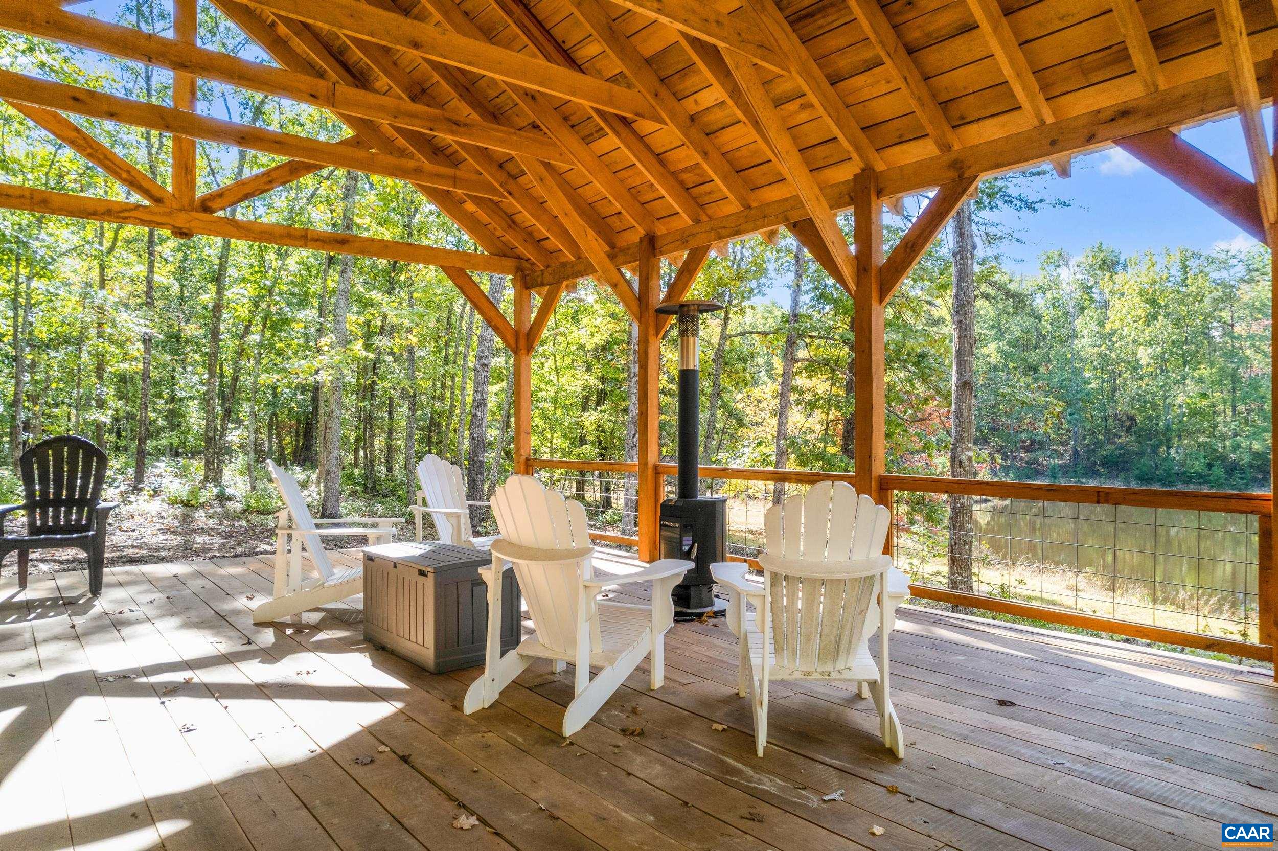 9915 Howardsville Road Howardsville, VA 24562 - Photo 10 of 68 a view of a patio with a table chairs and wooden floor