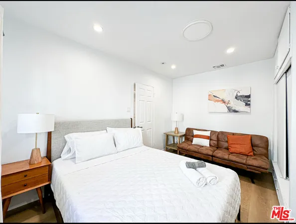 a bedroom with a bed and a lamp