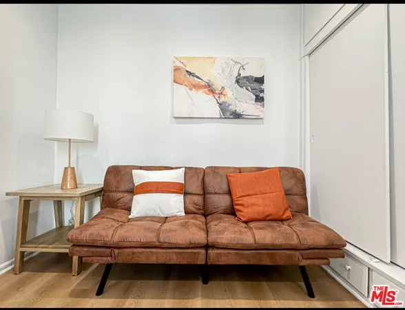 a bedroom with furniture and a lamp on table