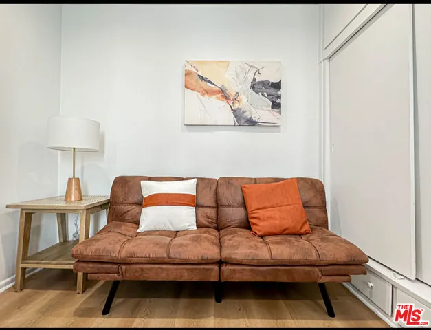 a bedroom with furniture and a lamp on table