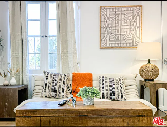 a bedroom with furniture and wooden floor