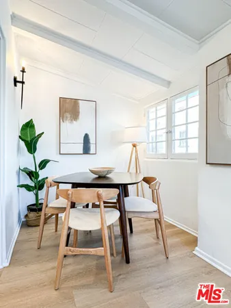 a living room with a table and a potted plant