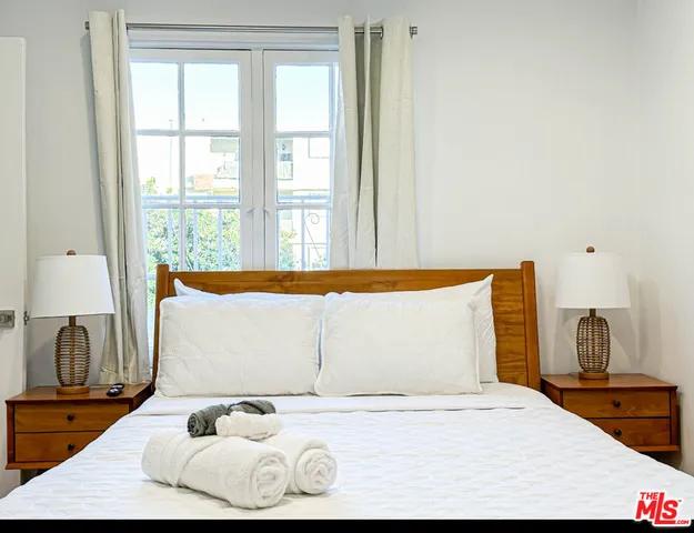 a bedroom with a bed and window