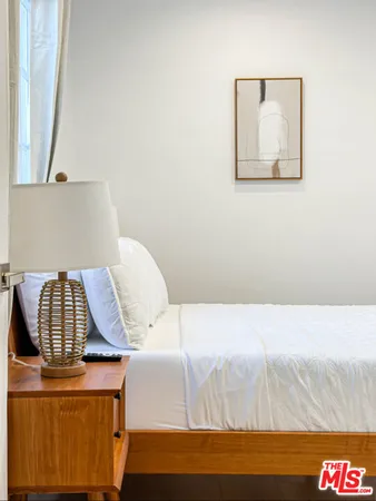 a bedroom with a bed and a couch