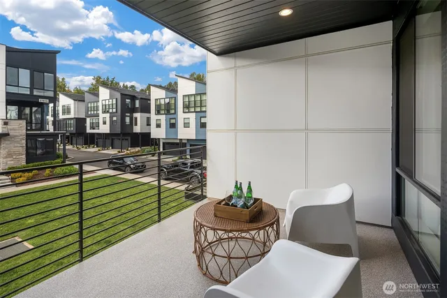 a balcony with furniture and a potted plant