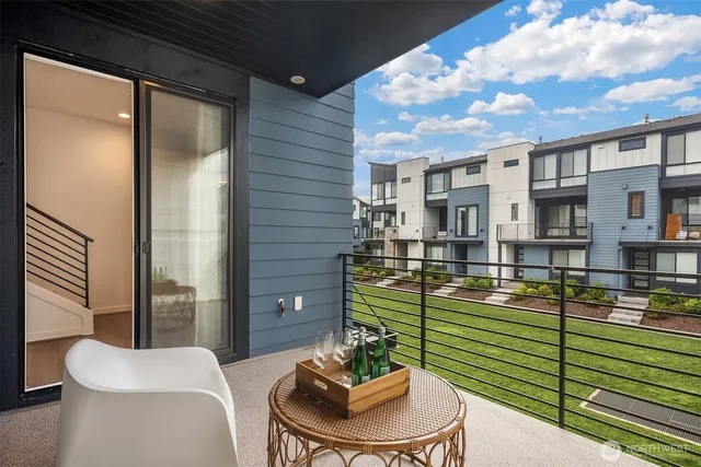 a balcony with furniture and a potted plant