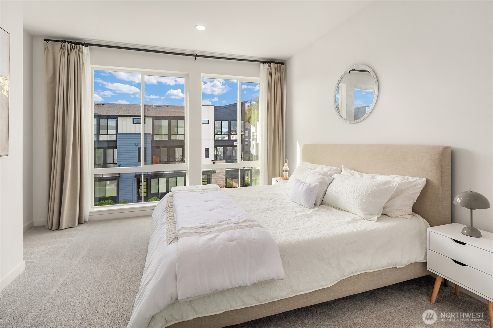 21822 25th Avenue Southeast, Unit B Bothell, WA 98021 - Photo 21 of 34 a bedroom with a large bed and a large window