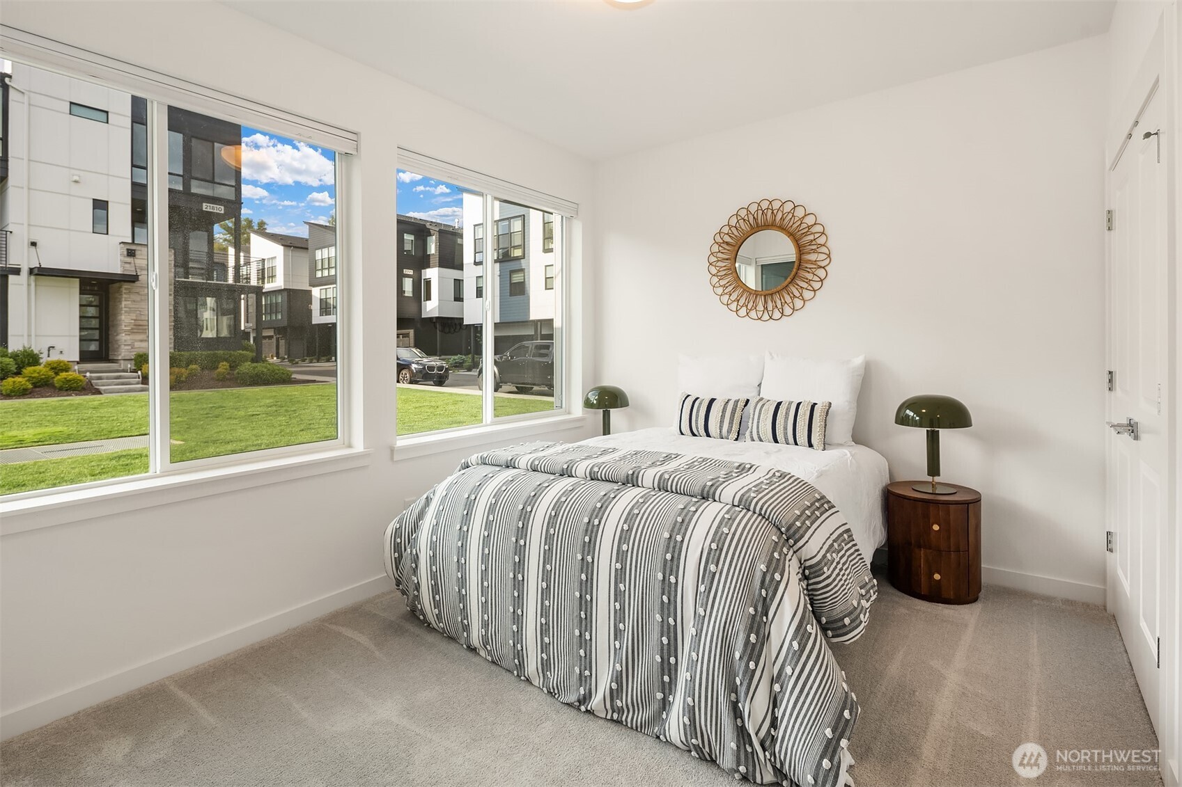 21822 25th Avenue Southeast, Unit B Bothell, WA 98021 - Photo 28 of 34 a bed sitting in a bedroom next to a large window